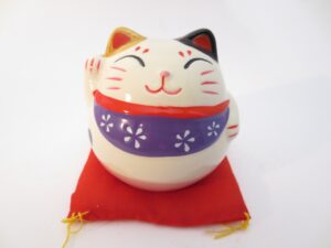 Lucky cat on red pillow