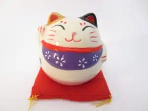 Lucky cat on red pillow